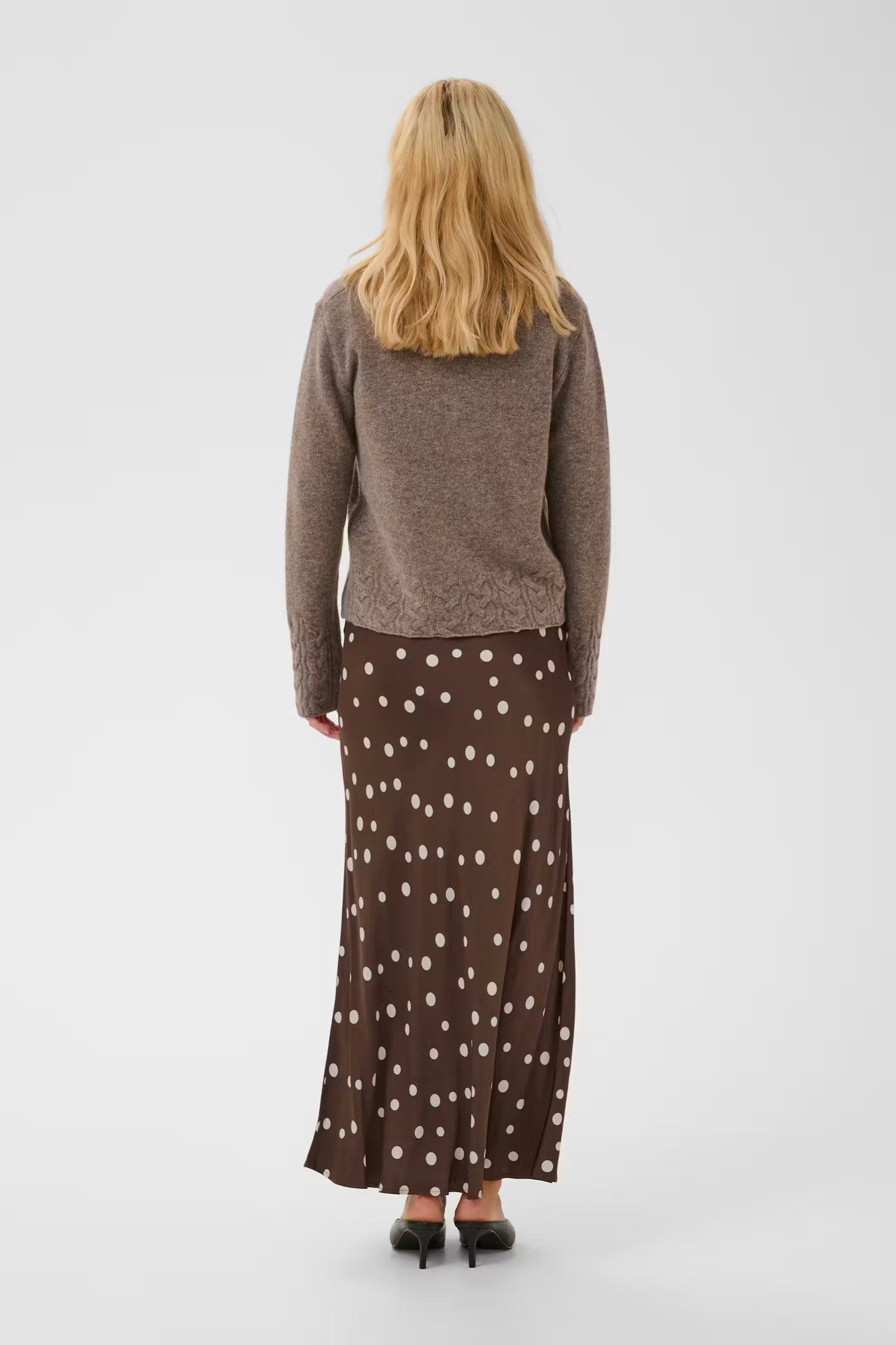 Back view of Culture Dotty Berna brown polka dot midi skirt styled with knitwear