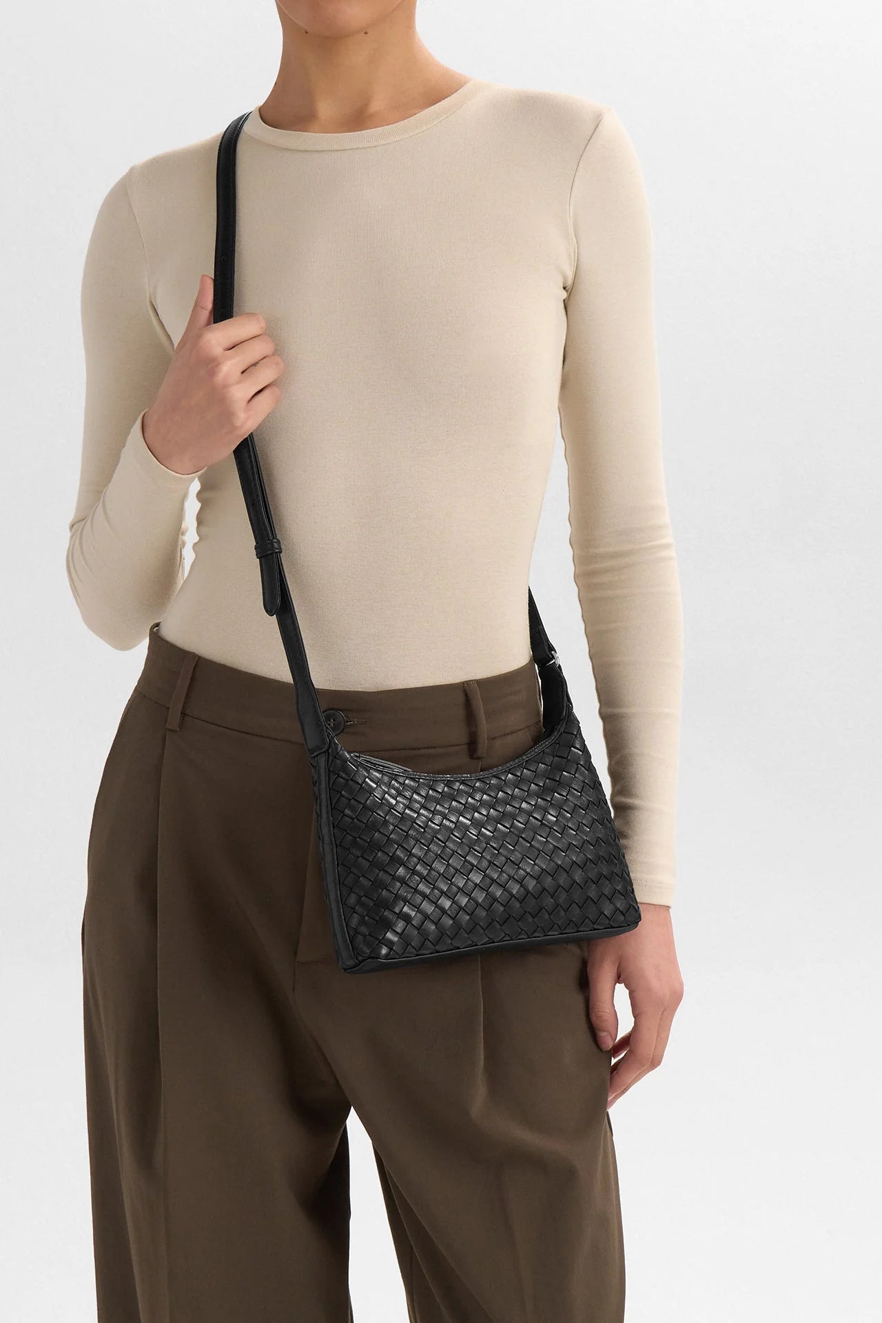 Markberg Avenya black woven leather crossbody bag worn across body