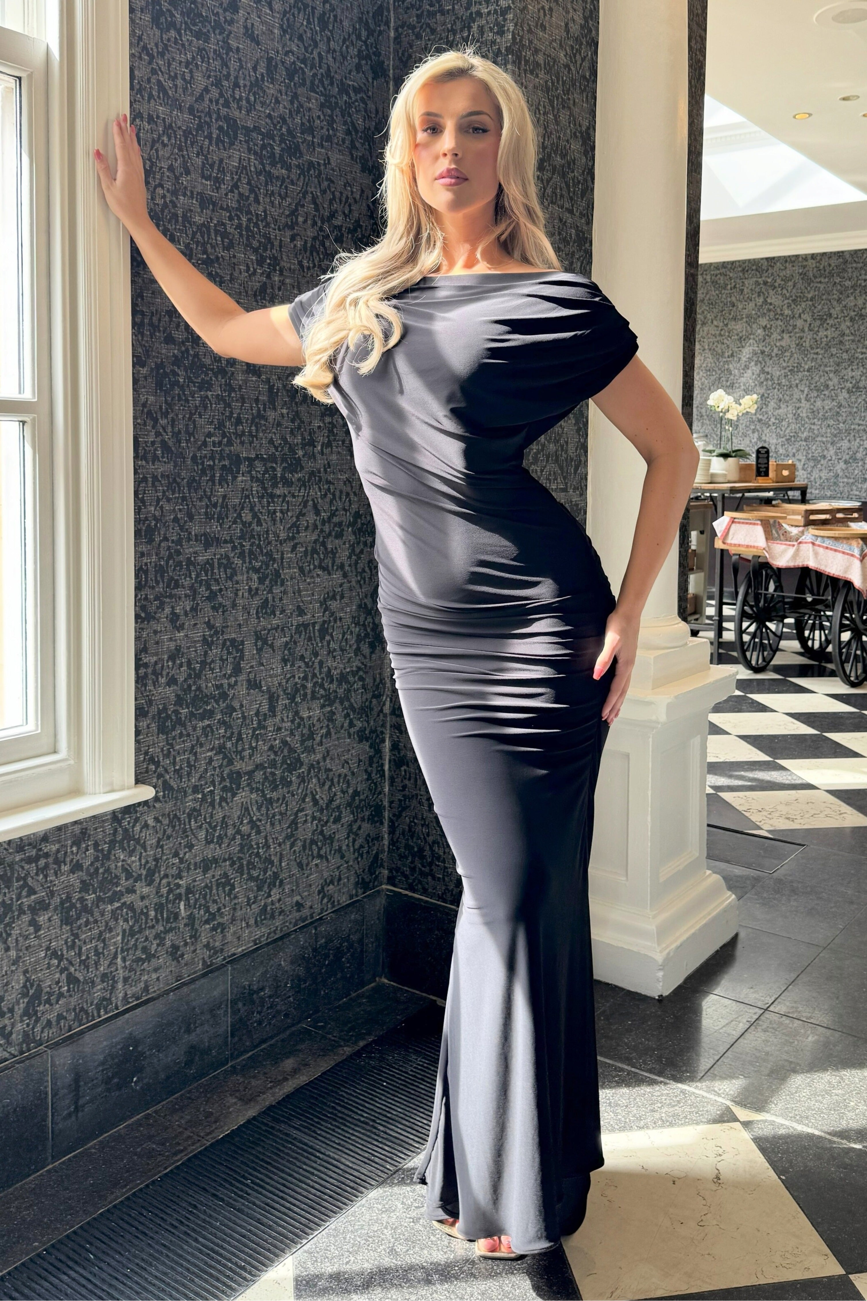 Atom Platinum black Bardot maxi dress side view with pleated silhouette