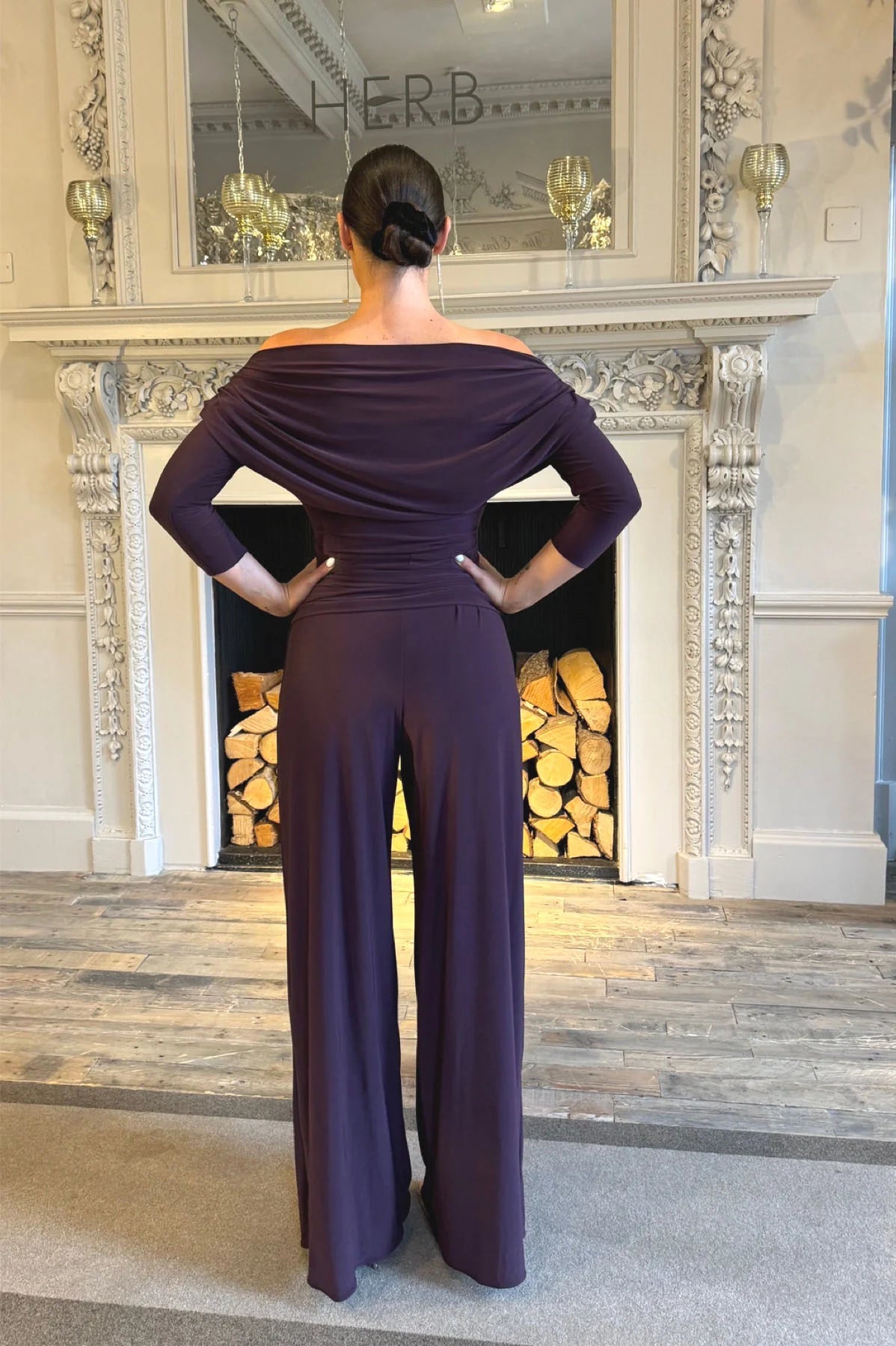 Back view of Atom Carbon Blackcurrant off shoulder wide leg winter occasion jumpsuit