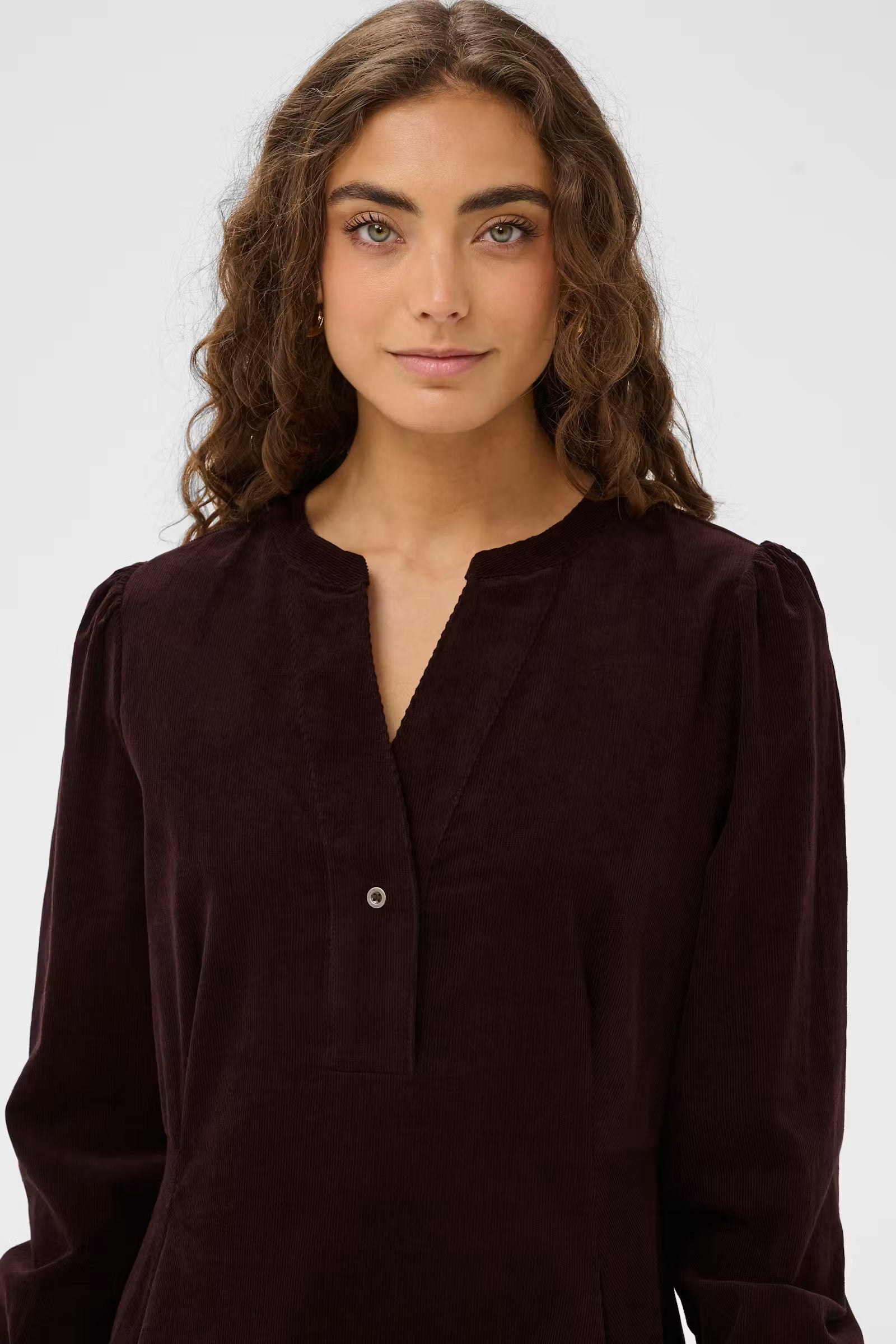 Close-up of Culture Rhaena dark brown corduroy dress split neckline