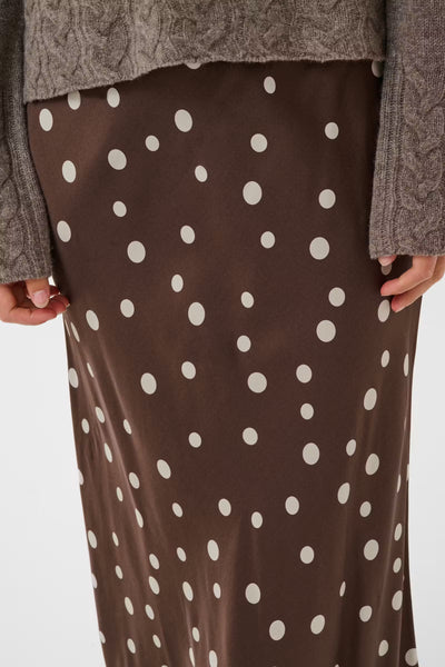 Close-up of Culture Dotty Berna brown polka dot midi skirt print and drape