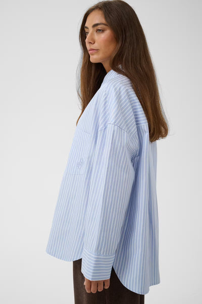 Side view of Culture Manga oversized blue striped shirt