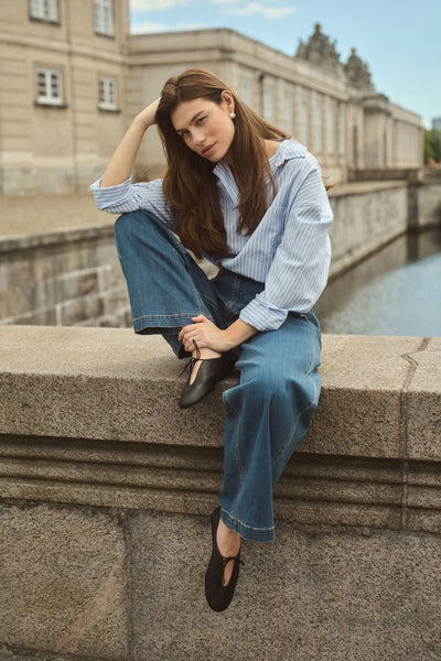 Culture Manga oversized blue and white shirt styled seated outdoors