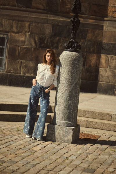 Culture Claramille statement collar blouse styled with embroidered wide leg jeans