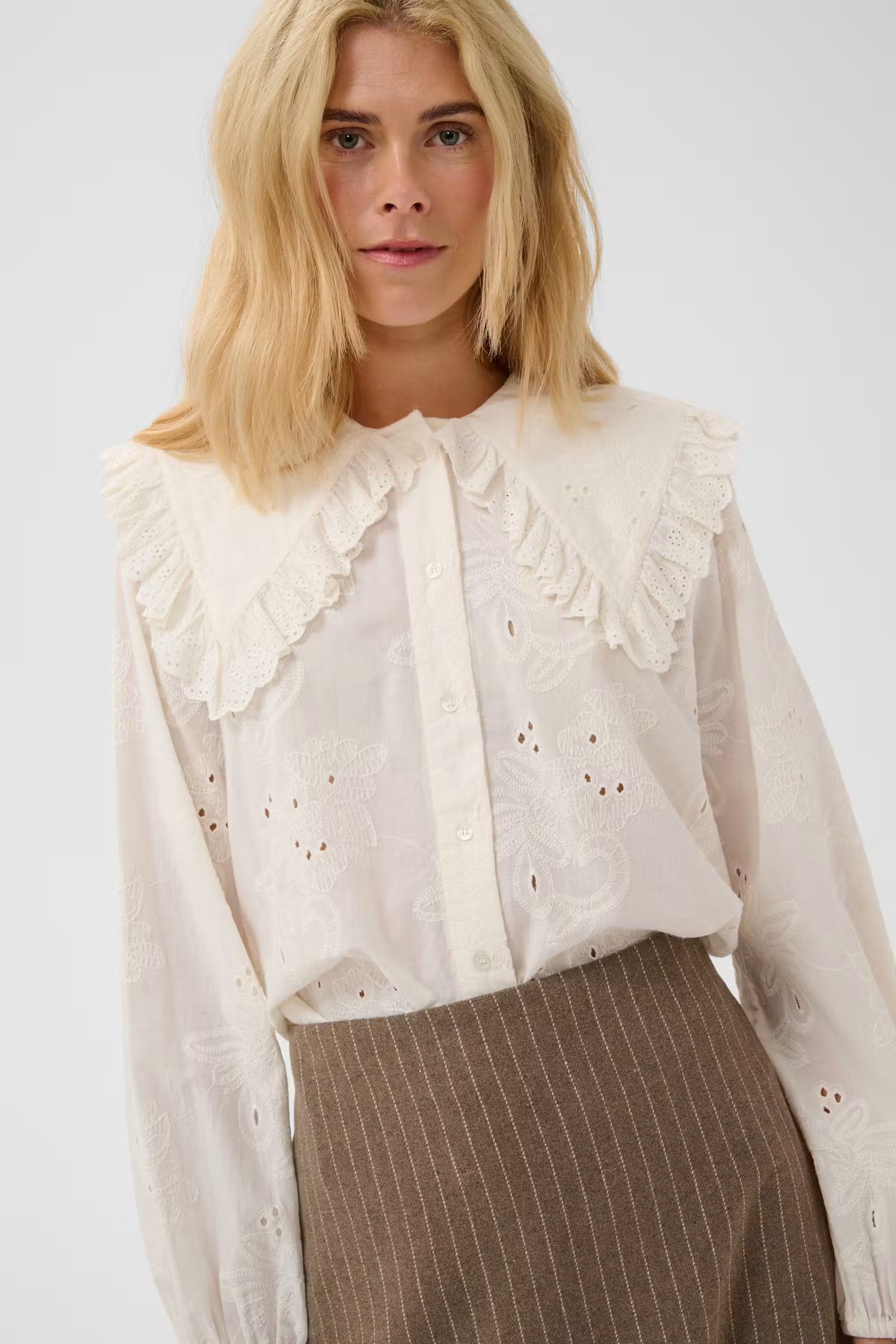 Close-up of Culture Claramille ivory blouse oversized ruffled collar
