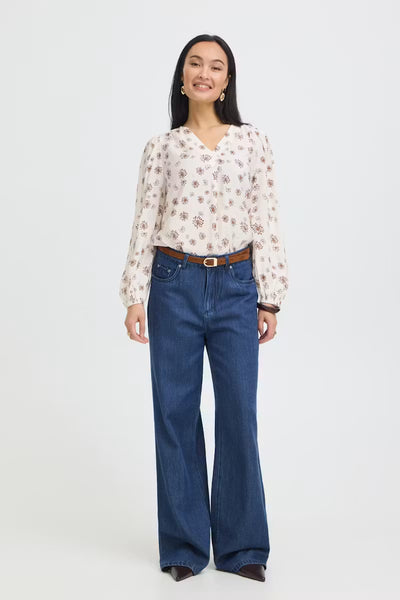 Full-length front view of Fransa Kalia white and red floral blouse with jeans