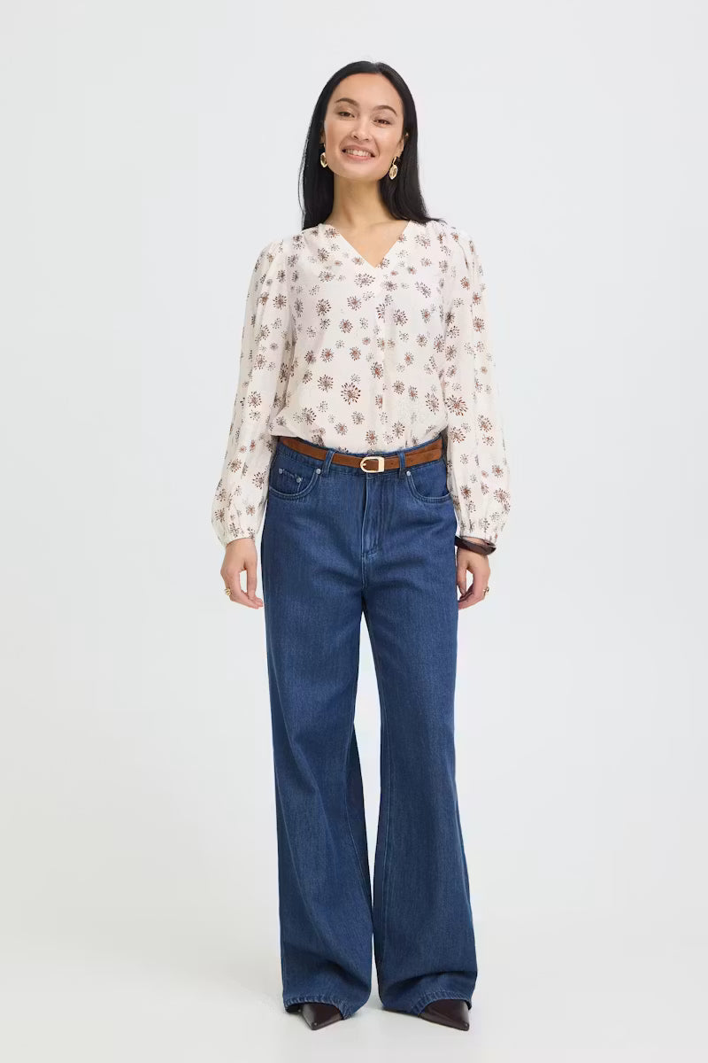 Full-length front view of Fransa Kalia white and red floral blouse with jeans