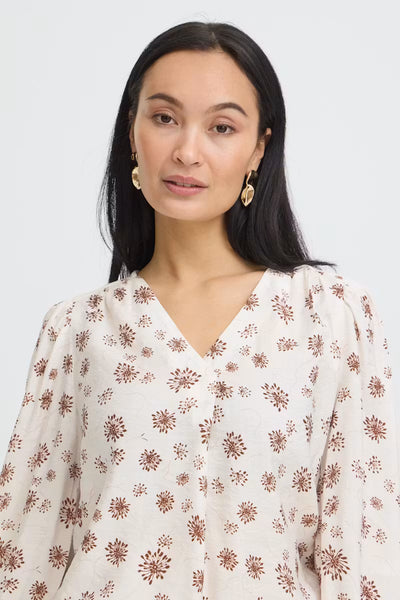 Close-up of Fransa Kalia red floral print blouse V-neckline and gathered shoulders