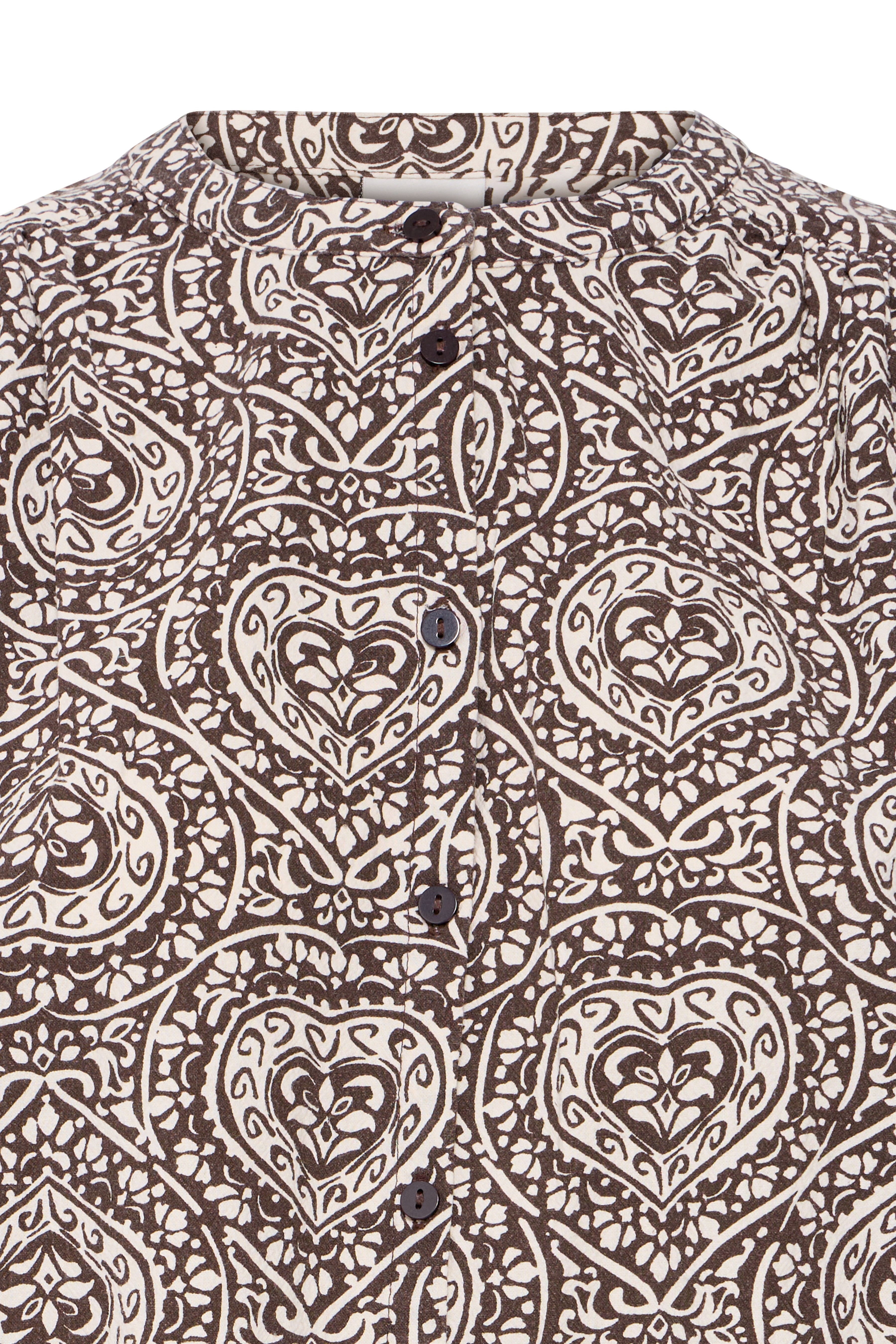 Close-up of ICHI Katilio folklore heart motif in brown and birch