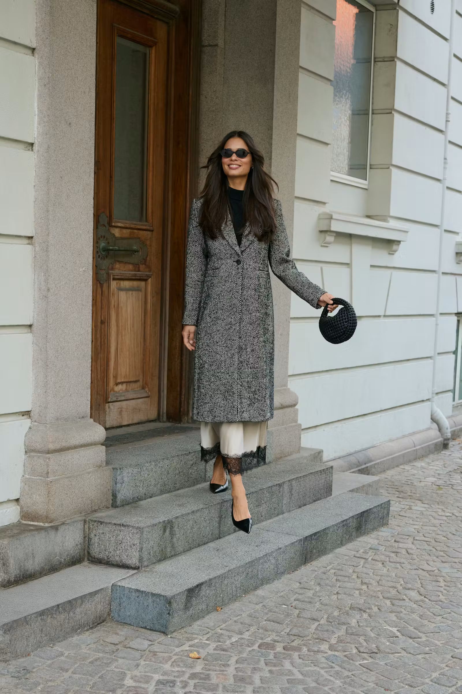 Kaffe Ofelia women’s herringbone long coat styled outdoors full-length view