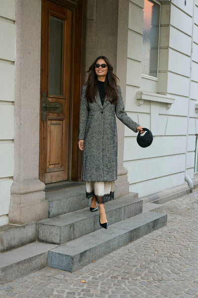 Kaffe grey herringbone coat styled outdoors with cream trousers