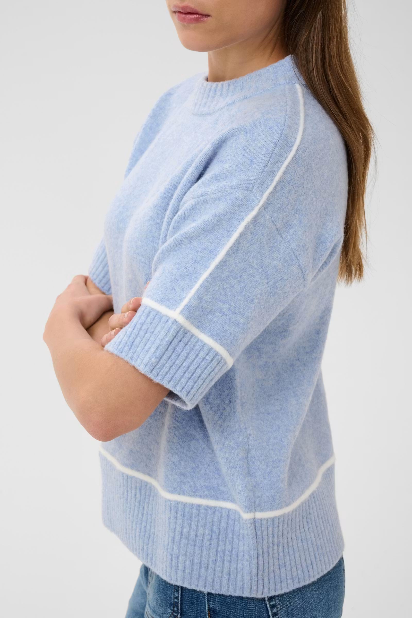 Side close-up of Kaffe Jinie light blue jumper with white sleeve piping
