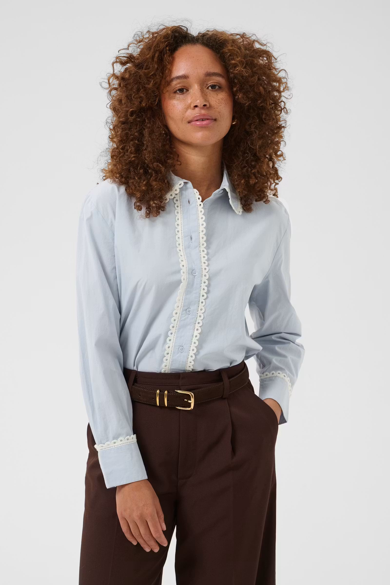 Kaffe Kaketty Blue Fog lace trim shirt styled with brown trousers front view