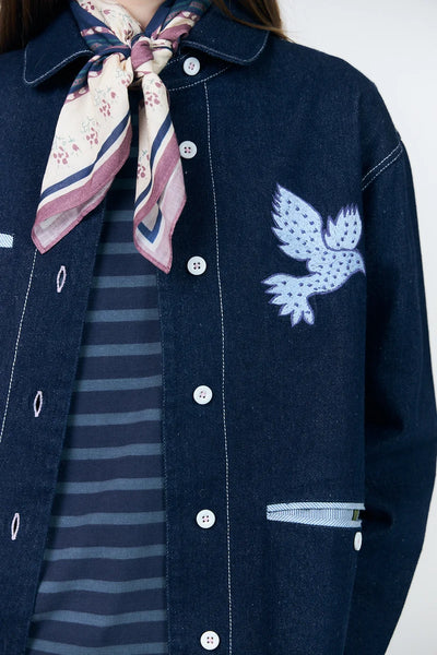 Close-up of Lollys Laundry Edda embroidered bird motif and decorative front pockets