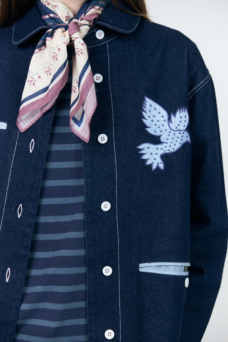 Close-up of Lollys Laundry Edda embroidered bird motif and decorative front pockets