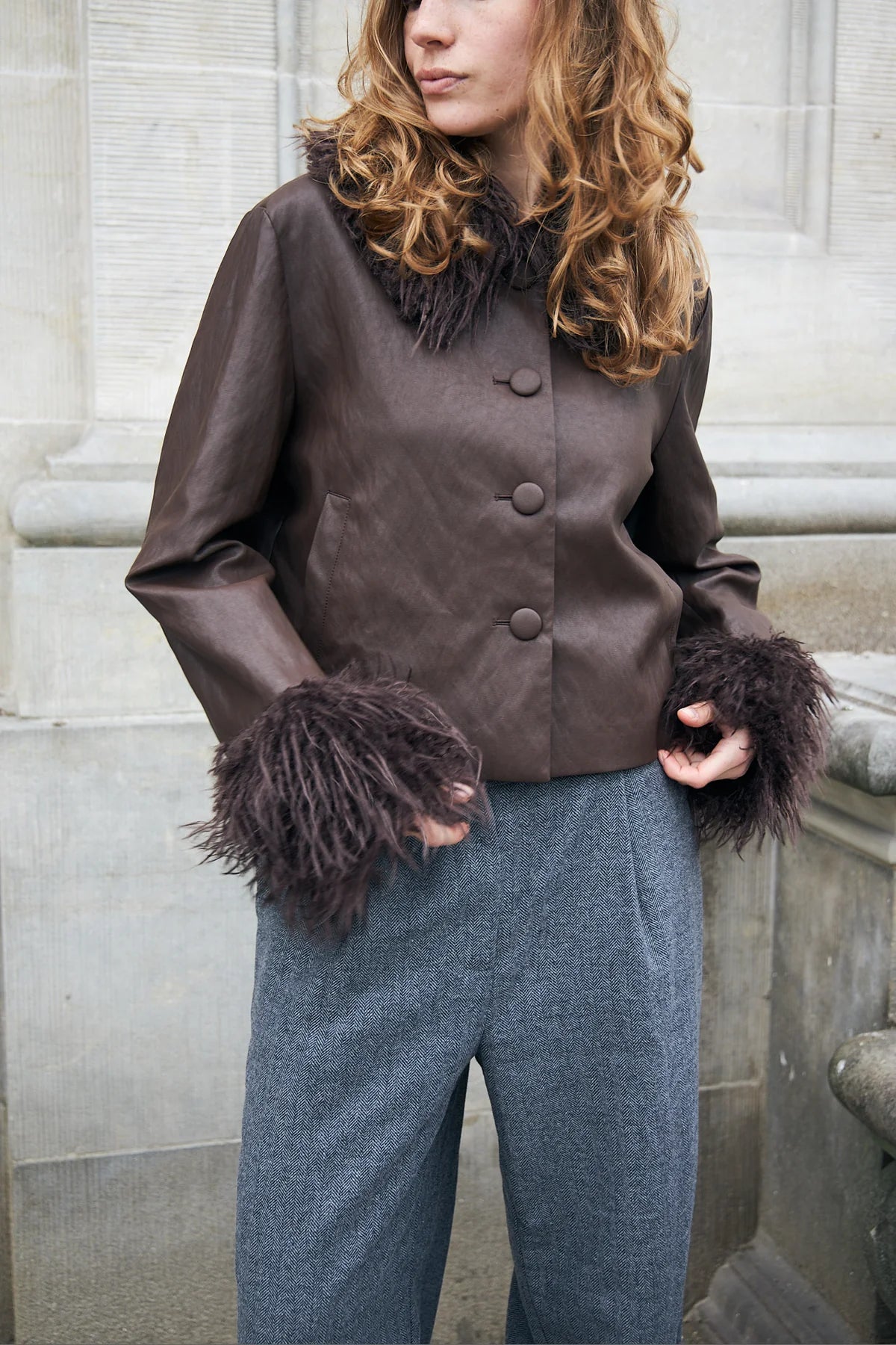 Close-up of Lollys Laundry Tracy brown jacket covered buttons and long-haired faux fur cuffs