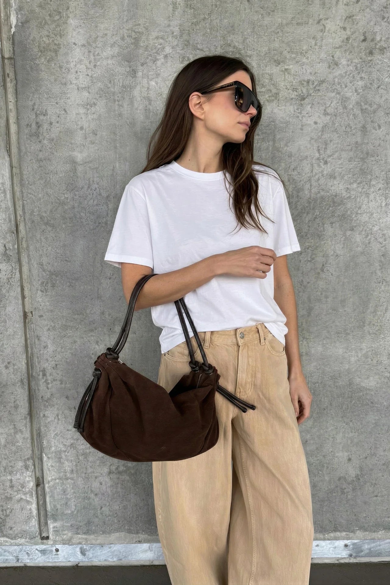 Markberg Reign Major Brown suede shoulder bag worn with white T-shirt