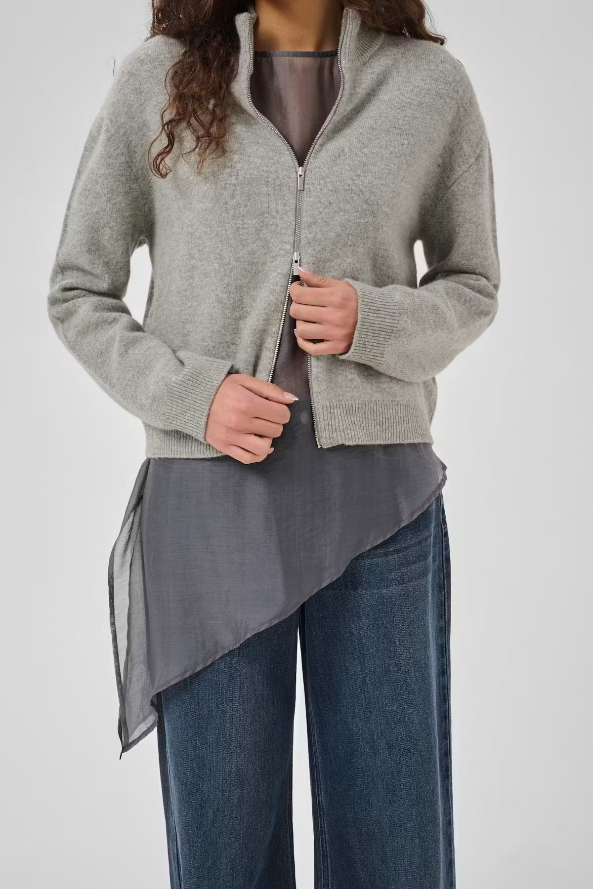 Close-up of My Essential Wardrobe Tracy grey zip cardigan layered over sheer top