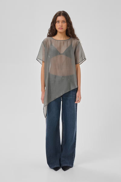 My Essential Wardrobe Smilla grey sheer asymmetric top full-length front view with jeans