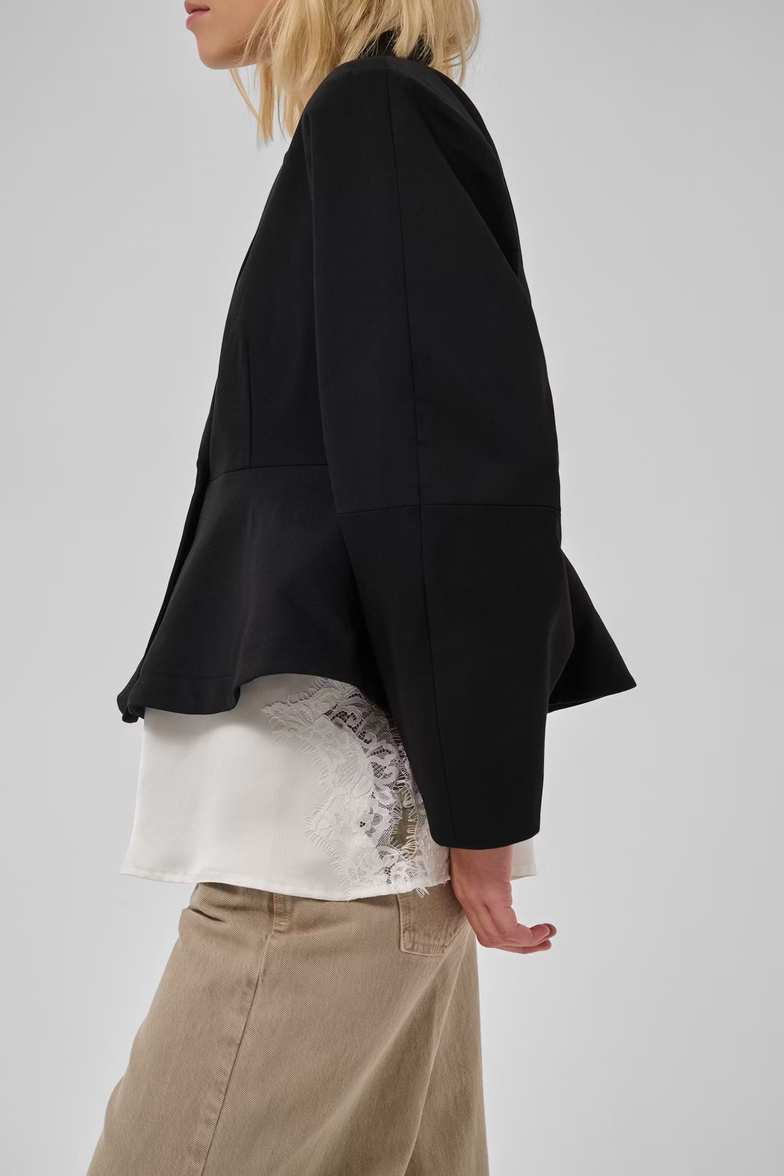Side view of My Essential Wardrobe Evie blazer showing the flared peplum hem