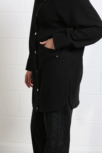 Close-up of Rant & Rave Joanna black coat button front and pocket detail
