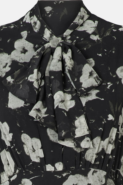 Close-up of Rue de Femme Paxton high tie bow neckline and floral print