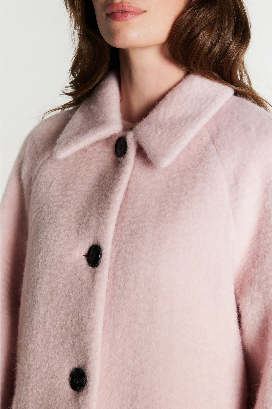 Close-up of Rue de Femme Addison pink coat rounded collar and dark buttons