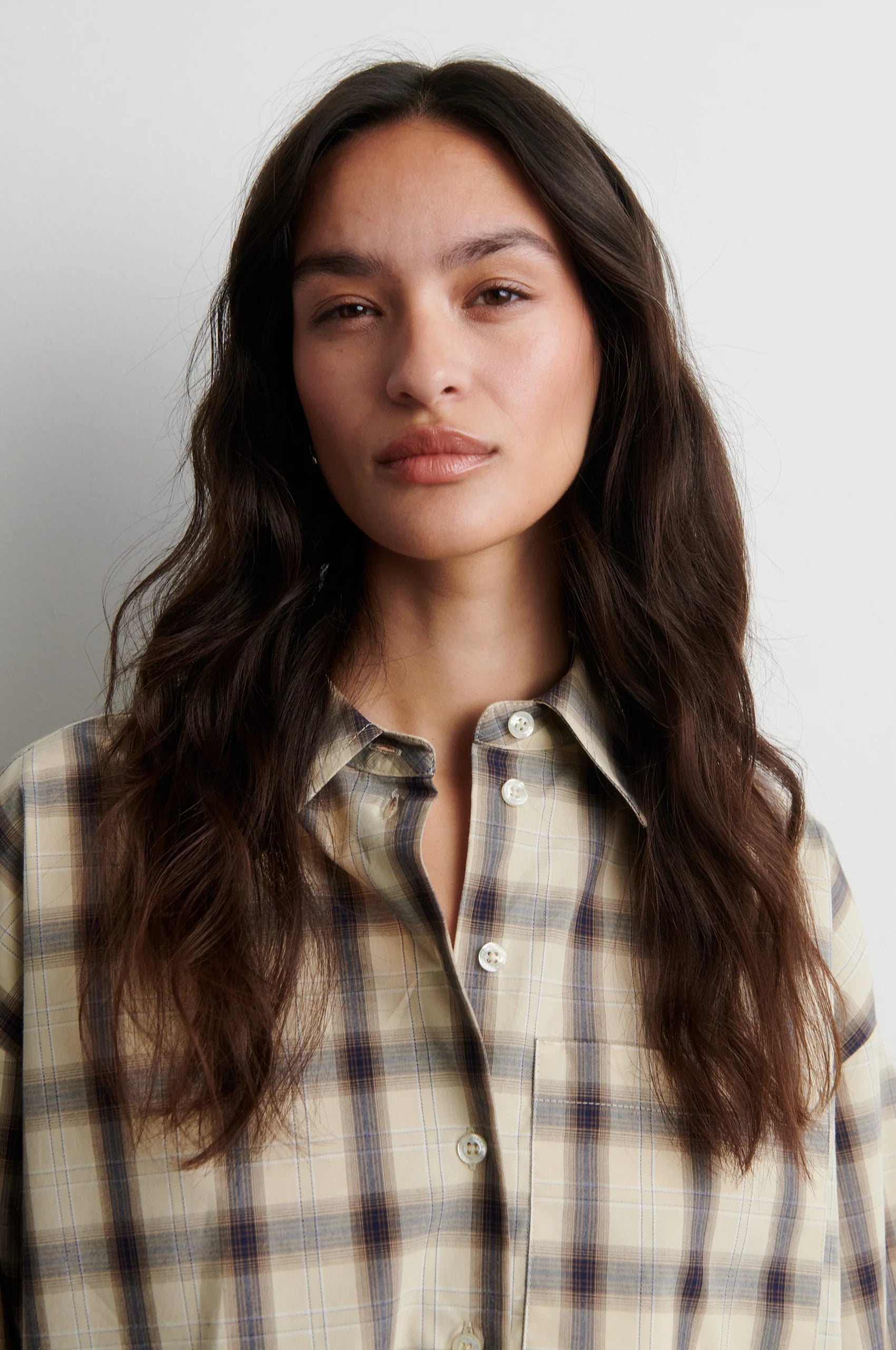 Close-up of Second Female Liria cream check shirt collar and button fastening